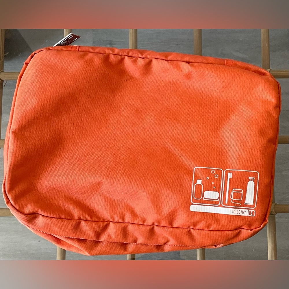 Orange toiletry bag w/ hanger.